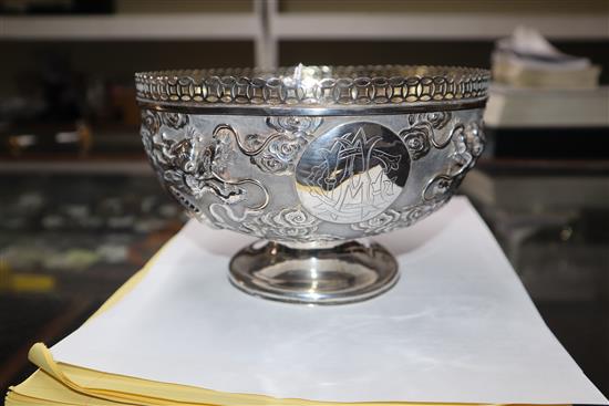 An early 20th century Chinese white metal pedestal bowl, embossed with dragons, 13.5 oz.